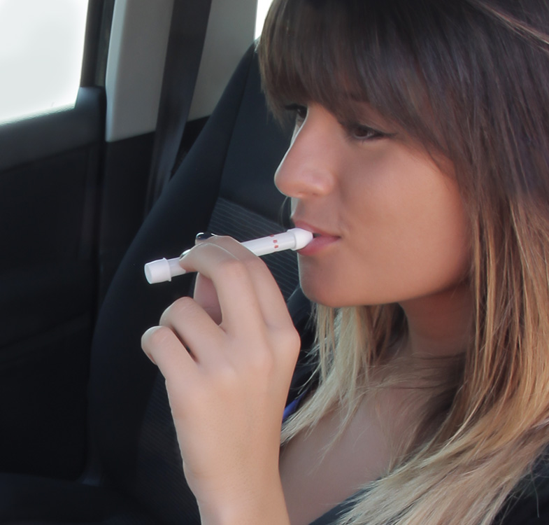 Woman using a Personal breathalyser